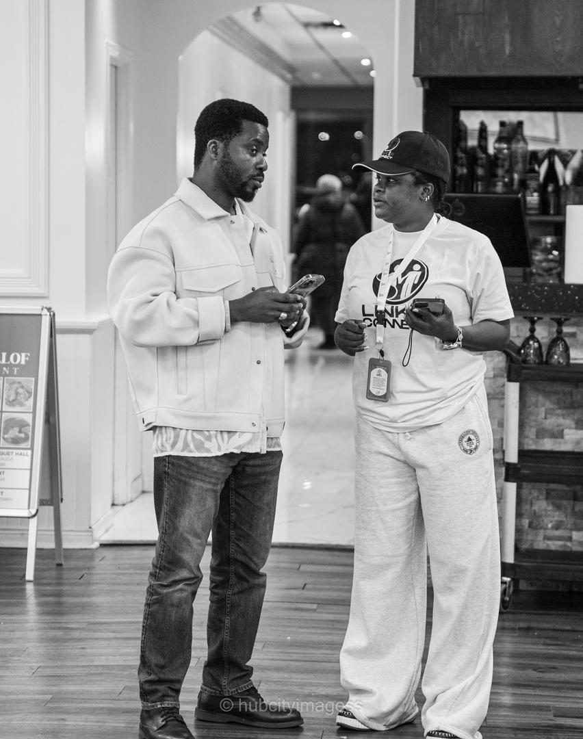Two members of the Linkup crew talking in the venue lobby