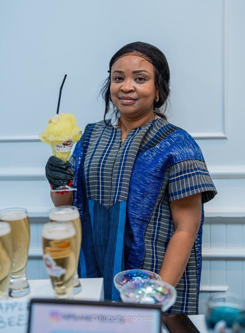 Vendor holding a frozen cocktail at a sips and treats stand
